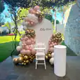 A pink and gold balloon package for a christening