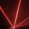 A red laser light is hired and shown in the dark.