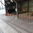 Red velvet rope on chrome bollards