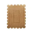 Natural scalloped jute rug with curved scalloped edging and woven texture, laid flat