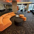 Sienna Apollo curved lounges with small and large ottomans and a black velvet ottoman at an event