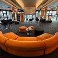 Sienna Apollo lounge pieces and large ottoman with black velvet ottomans at an event