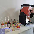 Slushie machine hire setup at a party drink station with flavoured syrups, cups, straws and a frozen drink dispenser in use