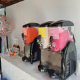 Two slushie machines on a table next to each other, serving a total of 180 drinks.