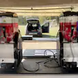 Two slushie machines are sitting on a table in front of a tent.