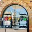 A Slushie Machine in front of a brick building, offering an impressive package of 240 drinks.