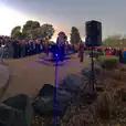 A crowd of people standing in front of a building, gathered for a Speaker Hire event.