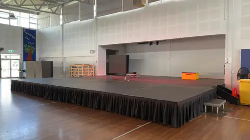 A large stage set up for an event inside of the hall