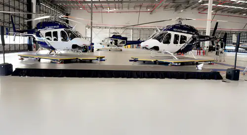 A stage set up for a conference with police helicopters in the background