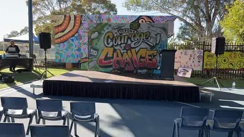 A stage set up for an outdoor event with a PA system