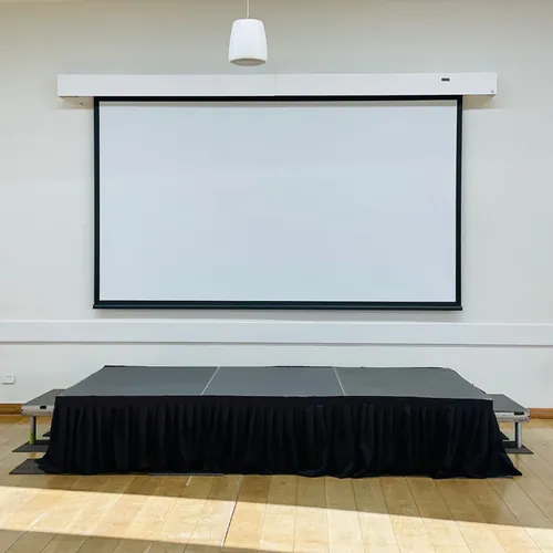 A stage set up with a projector for an event