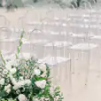 A white wedding ceremony with Victorian Ghost Chair Hire and white flowers.
