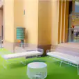 White Arrow 3 Seater Sofa with coffee table on a green carpet.