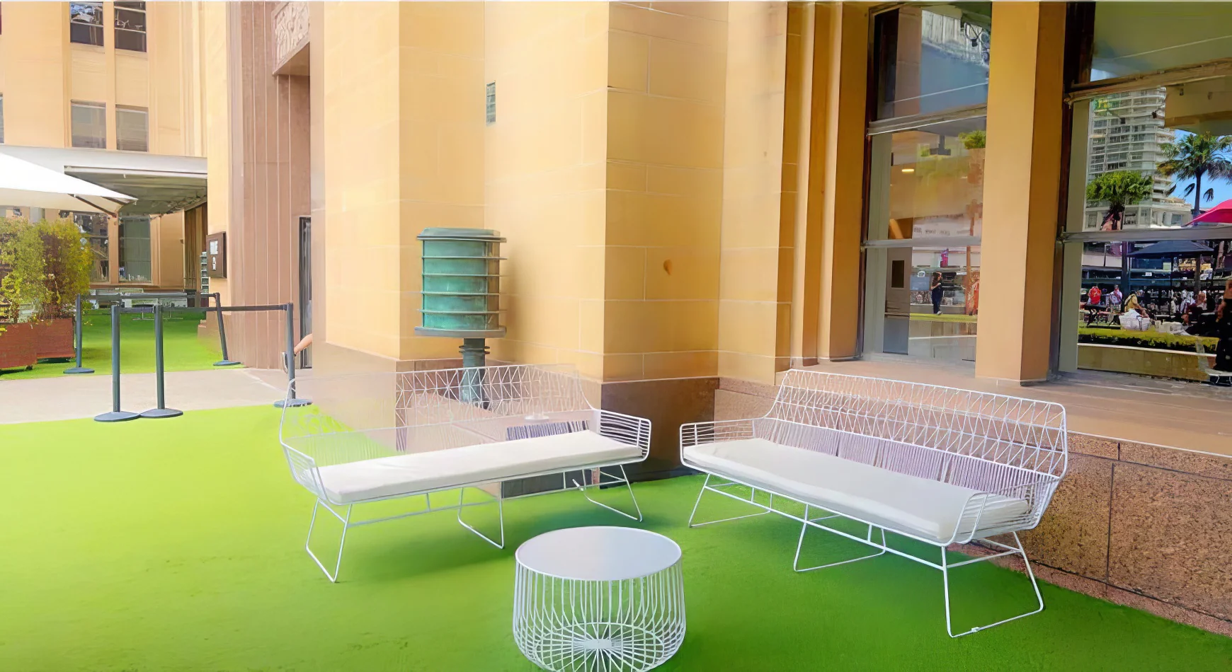 White Arrow 3 Seater Sofa with coffee table on a green carpet.