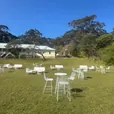 White Arrow sofa, white wire stools and a white wire cocktail table in an event lounge