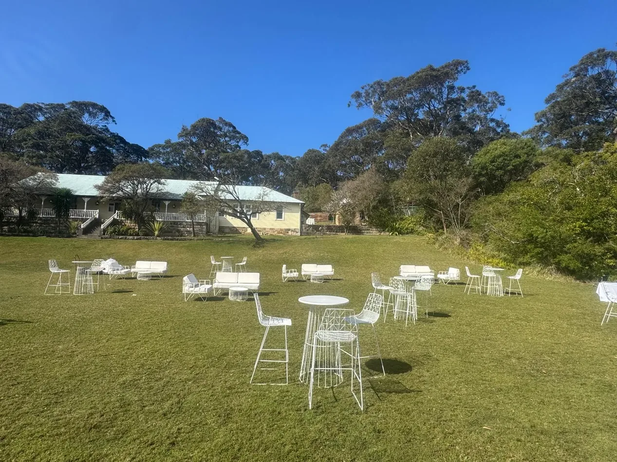 White Arrow sofa, white wire stools and a white wire cocktail table in an event lounge