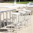 White thonet bentwood stool styled at a coastal event alongside high bar tables and wine barrels