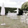 White thonet bentwood stools with back rest arranged at a high bar at a coastal wedding
