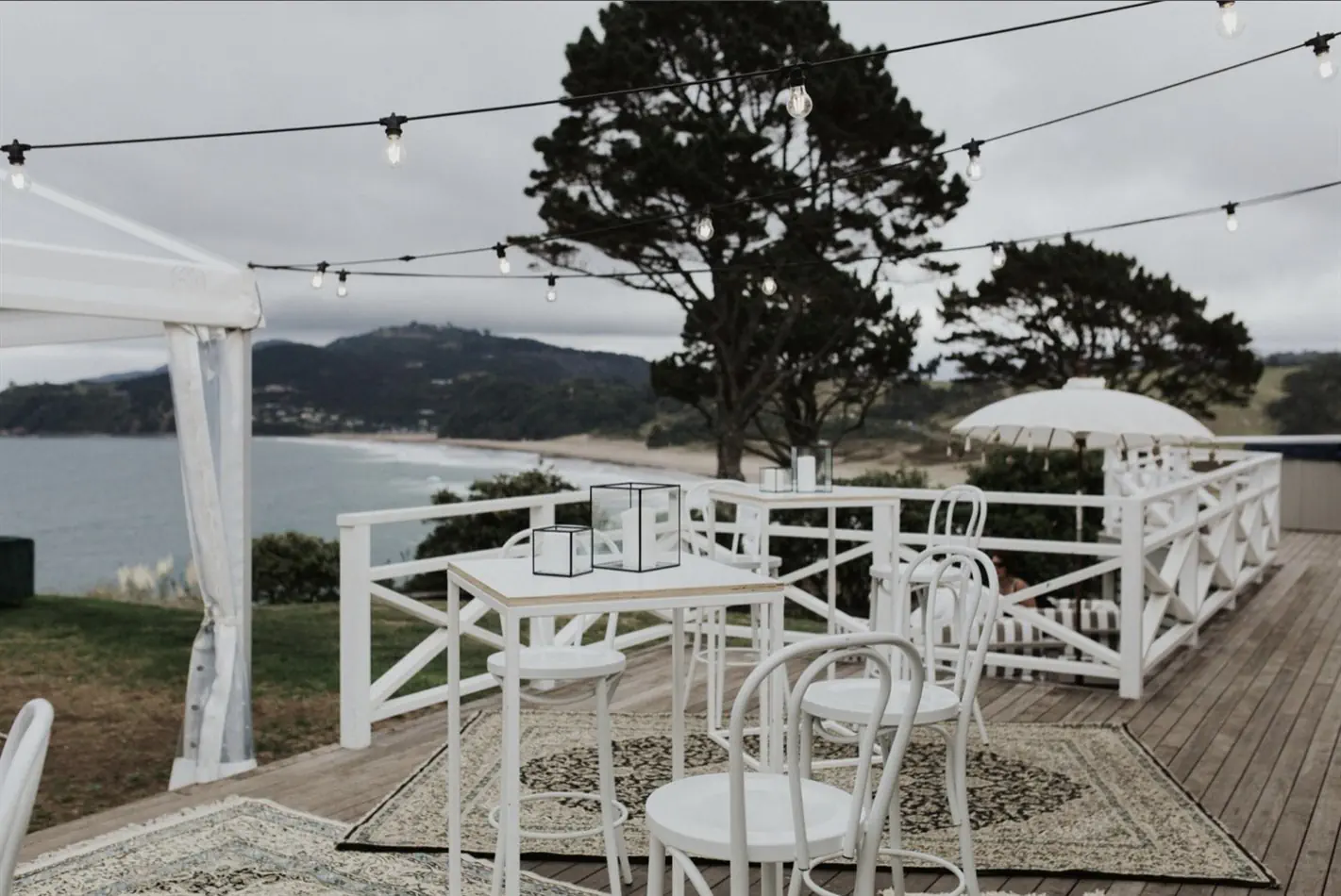 Multiple white bentwood back rest bar stools at a formal event venue