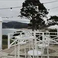 Multiple white bentwood back rest bar stools at a formal event venue