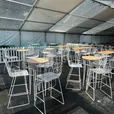 White hairpin tapas bar table with timber top at an event