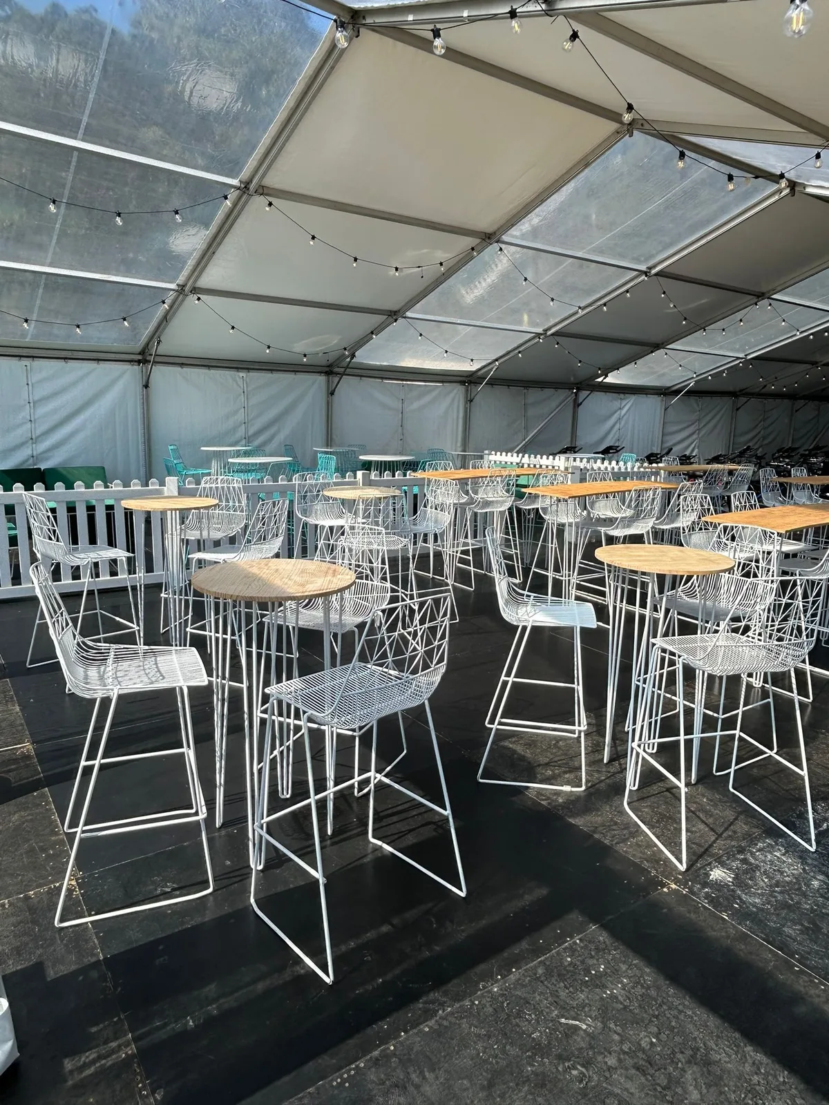 White hairpin tapas bar table with timber top at an event