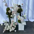 White plinths used for flower decorations