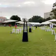 White table and chairs on a grassy area available for Tolix stool hire.