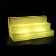A yellow LED shelf with a black background, perfect for showcasing products in a mesmerizing display.