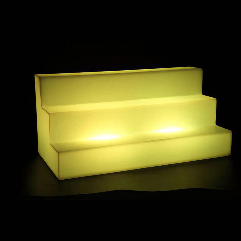 A yellow LED shelf with a black background, perfect for showcasing products in a mesmerizing display.